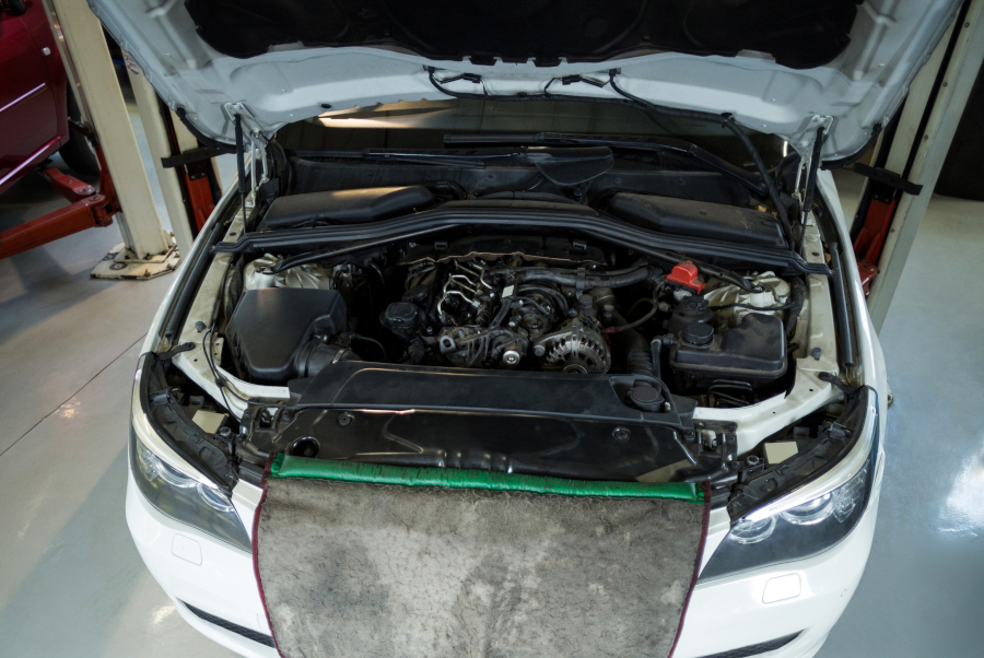 Female mechanic repairing a car in repair garage